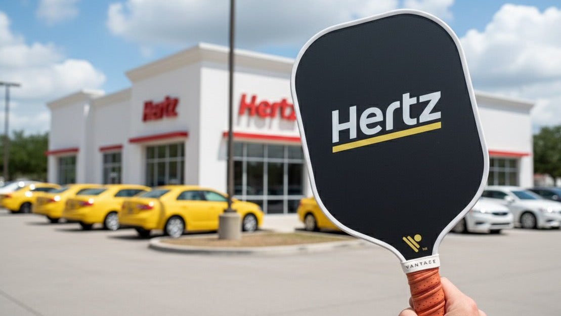 Hertz rental car building with a person holding a custom pickleball paddle with Hertz custom logo from vantaze pickleball